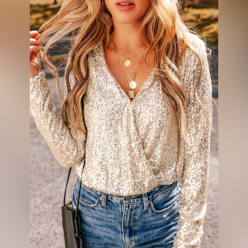 LULUMARI long-sleeve sequin wrap top 
a light champagne/cream color. XL